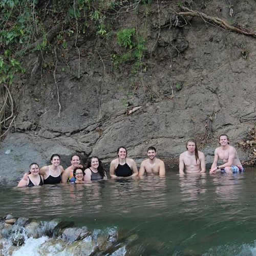 Photo of students in the 2018 Liberal Arts in Focus Costa Rica course bathing in the waters of Rio Gaucimal