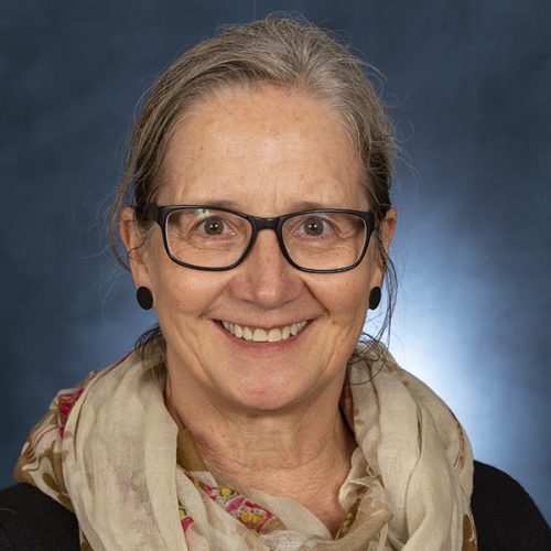female professor, Sarah, with glasses and scarf