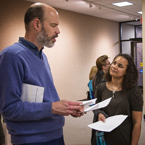 A professor and student discuss their papers