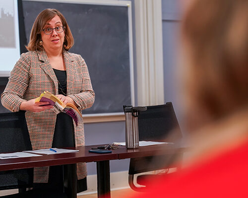 A Professor delivers a lesson in front of class