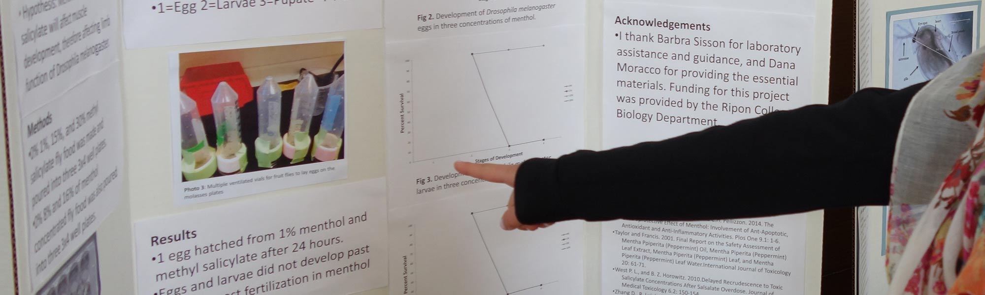 A student points to their research