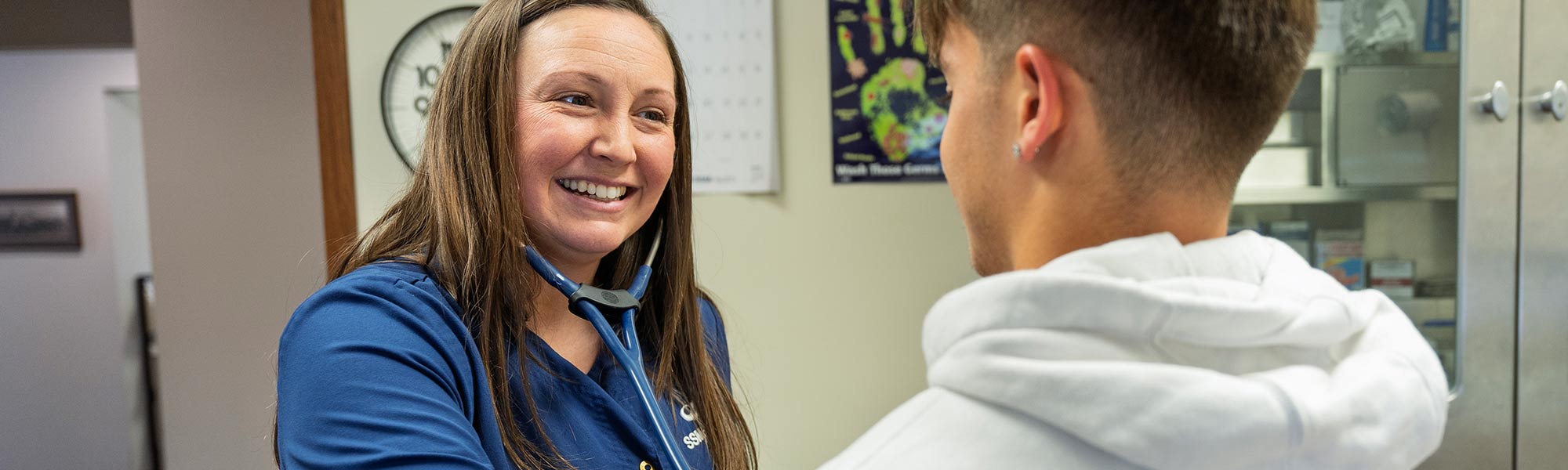 A doctor uses a stethoscope on a patient