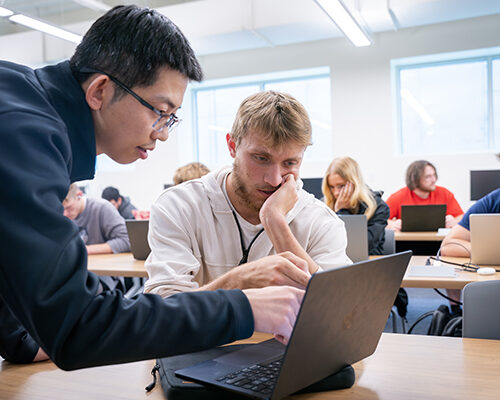 A friendly professor works with a student