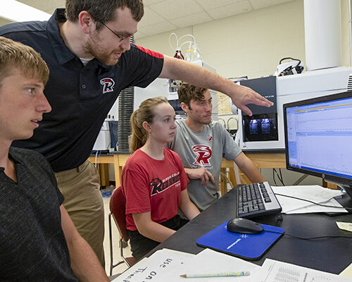 A professor shows progress on a screen