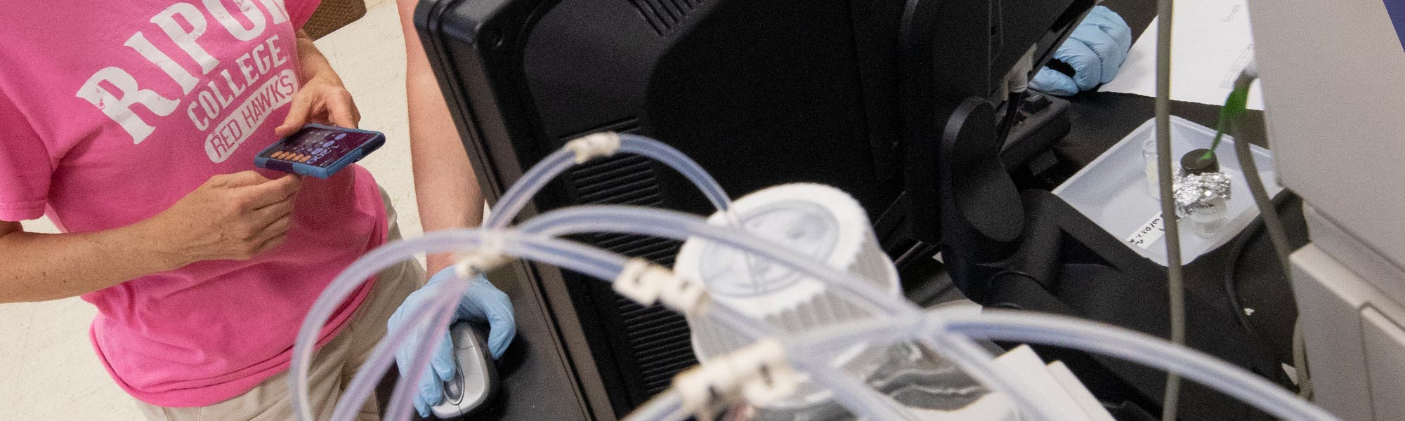 A professor and student work on chemistry via computer