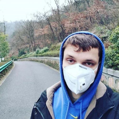Daniel Mikesell '14 wearing a mask in a Nanjing, China, park