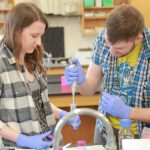 two students conducting a chemistry experiment in the lab at Ripon College