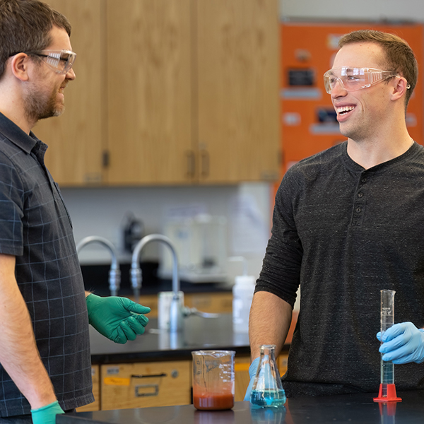 Associate Professor of Chemistry Patrick Willoughby works with student in the chemistry lab