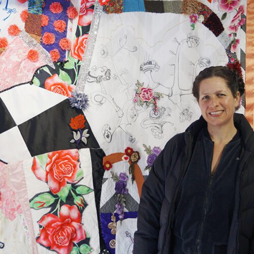 Artist Lisa Marie Barber standing in front of her work