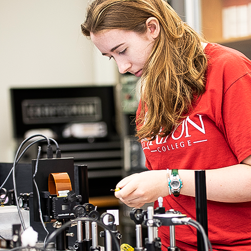 Female student working with lab equipment