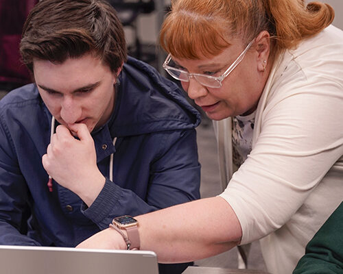 A professor works with a student