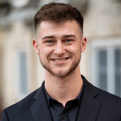 Owen Mehring stands in front of Great Hall