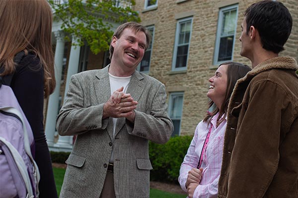 Chris Ogle talks with students in front of the Res Halls in 2005