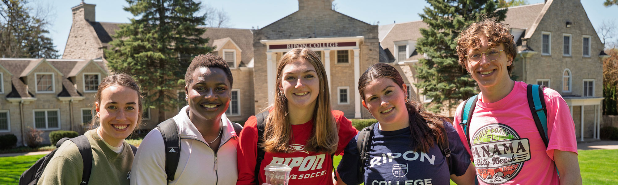 A group f students gather in front of Harwood Hall