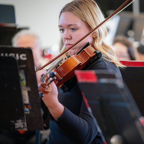 Student plays the viola from sheet music