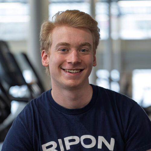 A student in Ripon Gear smiles