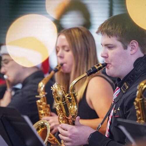 Three students playing brass instruments during the Holiday Concert
