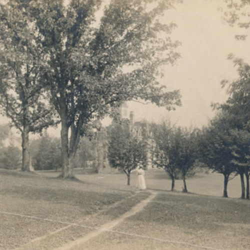 A woman walking towards bartlett hall