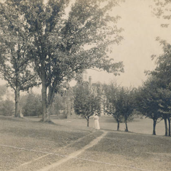 A woman walking towards bartlett hall