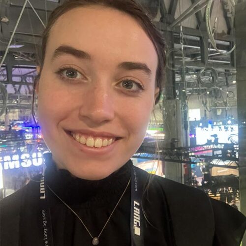 Natalie McNeely at a convention center smiles for the camera