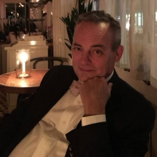 A dashing looking gentleman in a fancy restaurant