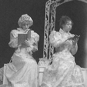 Two actresses on stage in fancy dresses
