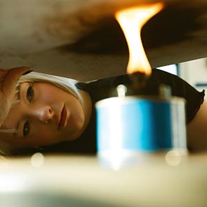 Artist applying flame to art