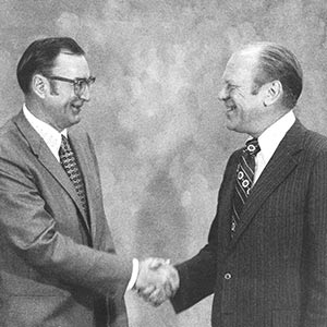 Bill shaking hands with President Ford