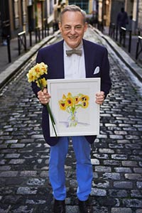 Charlie with one of his drawings on a cobblestone street in Paris