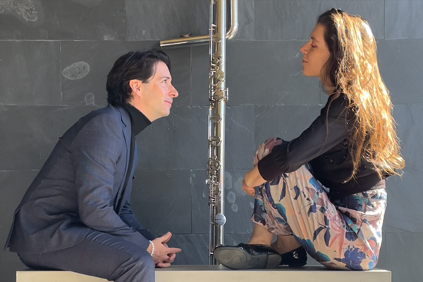 Two musicians look at each other intently