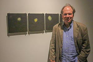 Thompson stands in the Caestecker Gallery with his art.
