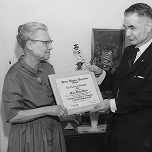 Weeks receives an award for her hard work.
