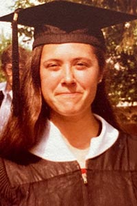 Bundock stands in Commencement gear