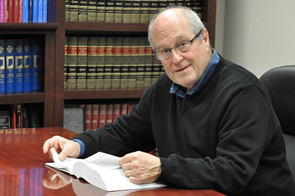 Lawyer sitting in a room with many books