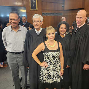 A group of judges stand in a swearing in ceremony