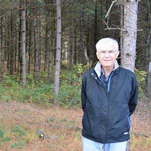 Wilcox stands in wide wooded area