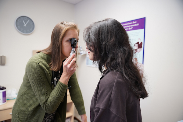 A member of the Health Services team at Ripon examines a students eye