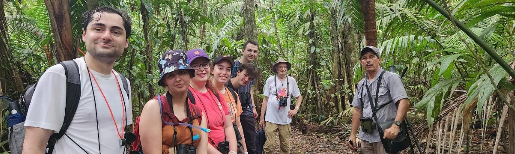 A group of students in dense almost jungle area