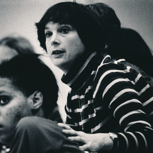 Coach rests her hand on players back