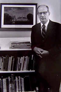 Miller stands with many books. 