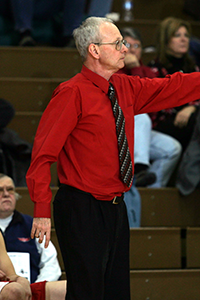 Basketball coach pointing down the court.