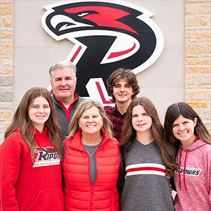 The Kahl Family stands beneath a Red Hawk R