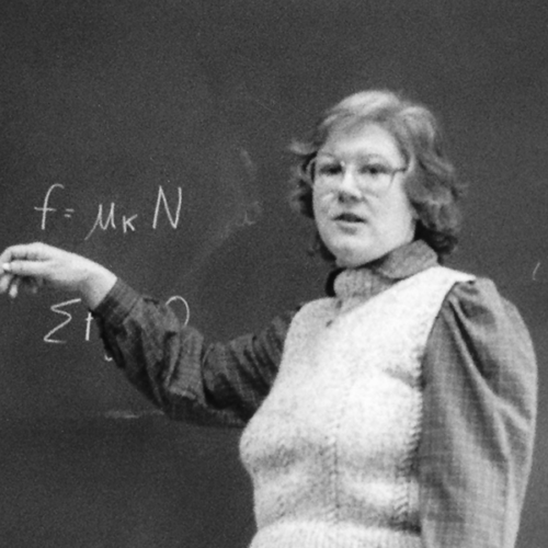 Physics professor in front of chalkboard