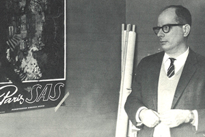 Miller teaches in class with a giant Paris poster. 