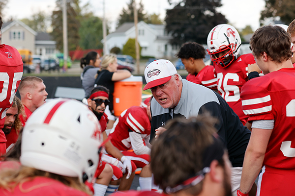 A fiery looking coach gets his team hyped.