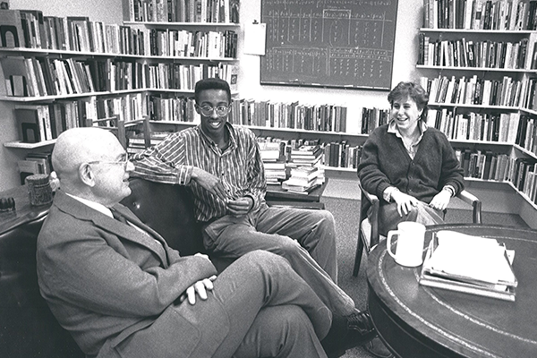 A professor and two students discussing philosophy.
