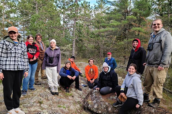 A group of students in a dense forest.