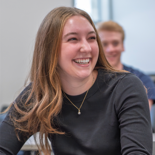 A girl smiles in class