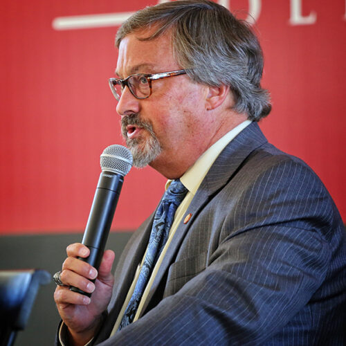 Rick speaking into a microphone.