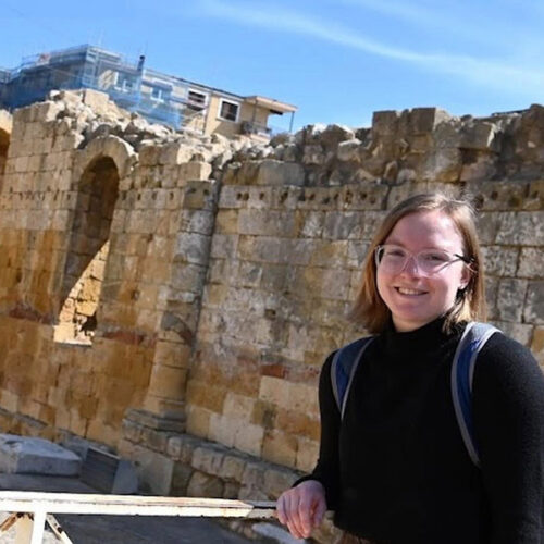 A Ripon Student in front of very old architecture